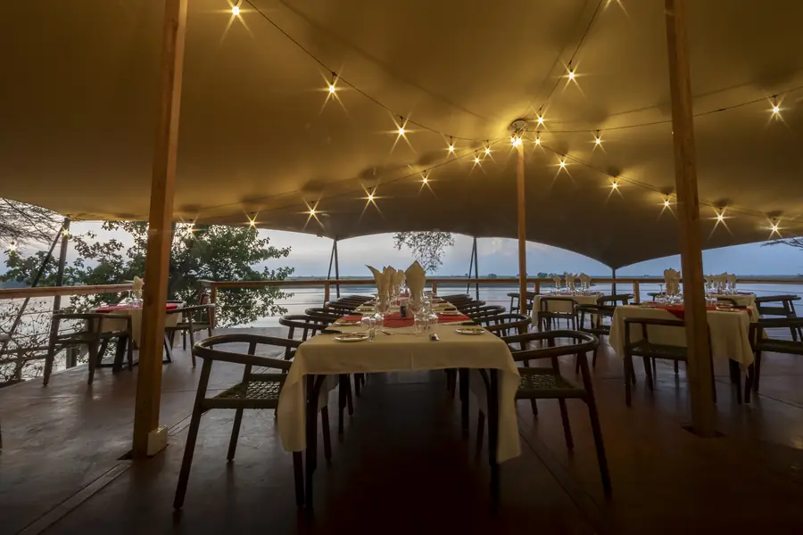 Tables set for dinner beneath the tented canopy